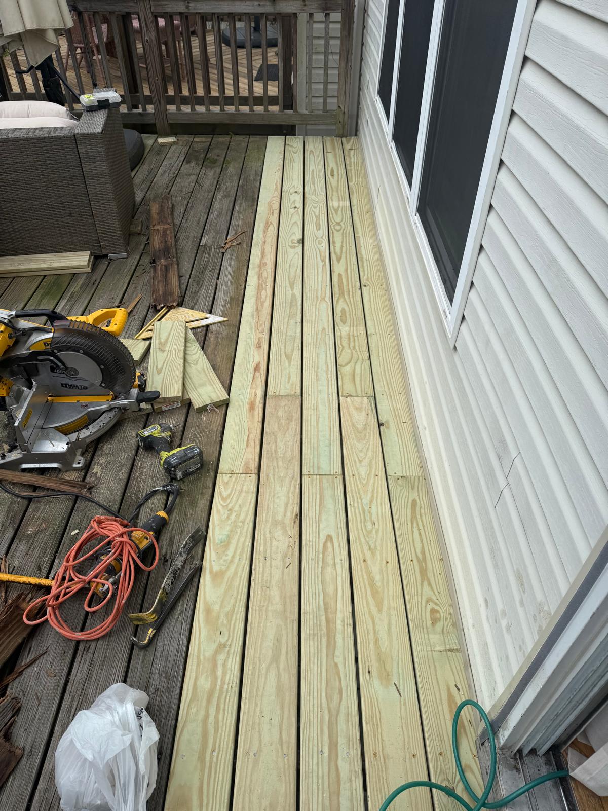Old deck boards being replaced with new lumber